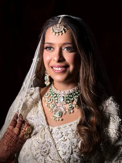 The bride with her veil, looking ethereal and classic. The makeup is soft yet defined, perfect for a timeless look.