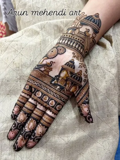 A single hand design filled with traditional motifs like a doli, kalash, and lotus flowers.