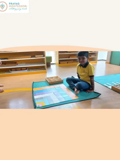 This student is in the process of building the Decanomial Square, carefully placing the colored bead bars to form the pattern.