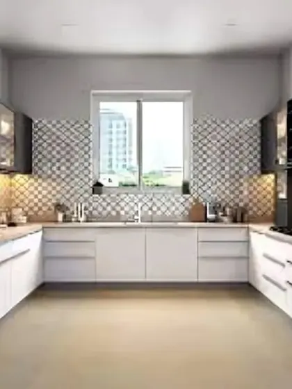 This U-shaped kitchen is designed for maximum efficiency, with ample counter space and storage. The black and white cabinets are paired with a patterned tile backsplash, adding a graphic element to the design.