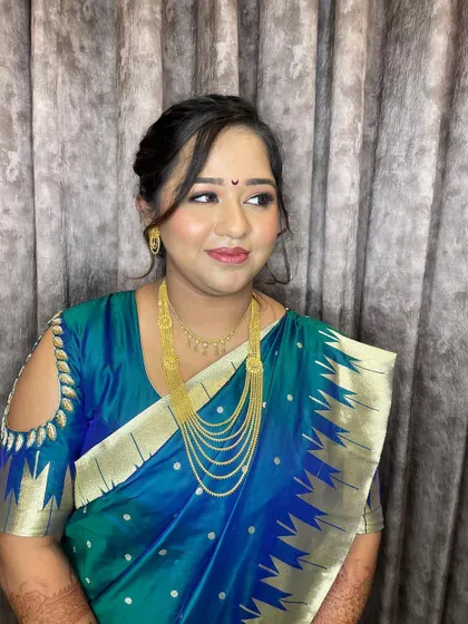 A beautiful, traditional look for this client's engagement. The makeup is soft and glowing, complementing her blue silk saree.