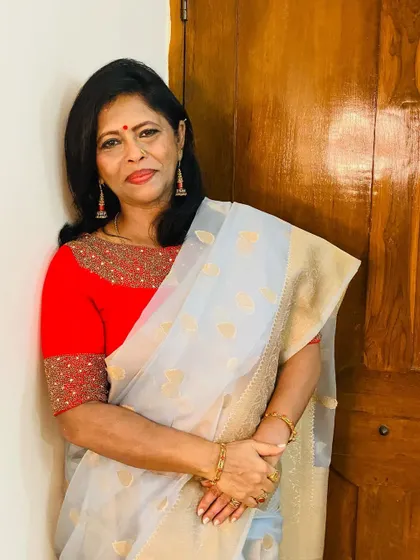 A light grey organza saree with gold leaf butis. I paired it with a vibrant red blouse to create a stunning contrast that is both modern and festive.