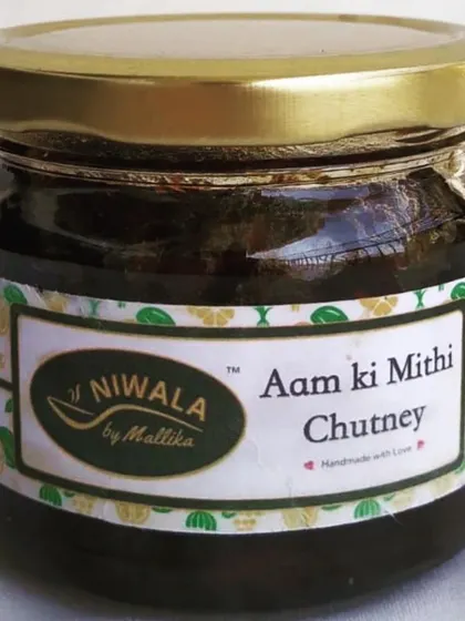 A jar of my sweet and tangy Aam ki Mithi Chutney. Made with raw mango and organic jaggery, this is a delightful accompaniment that can be paired with snacks, parathas, or even as a spread.