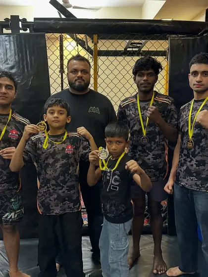 Standing with my team of champions after a weekend of dominant performances. My guidance helps them translate raw talent into medals.