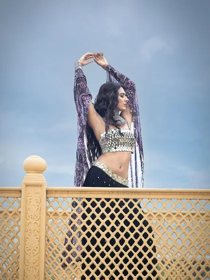 A dramatic shot against the sky, capturing a sense of freedom and movement in this beautiful ensemble by Sajeda Lehry.