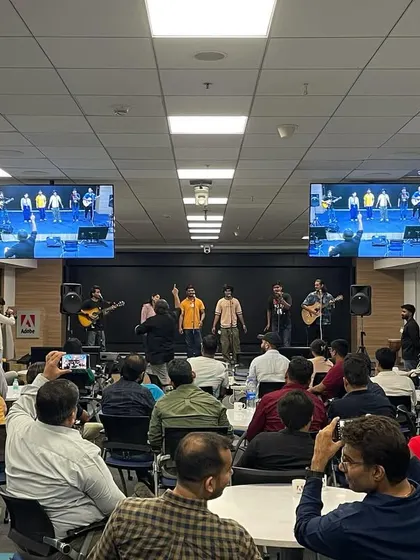 The audience at Adobe enjoying the performance by our Kalakaar fellows. The setup with multiple screens ensured everyone had a great view of the stage.