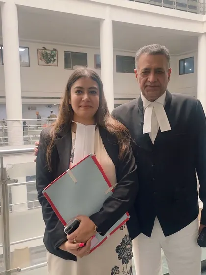 With a senior colleague inside the court building. Learning from experienced lawyers is a continuous process in this profession.