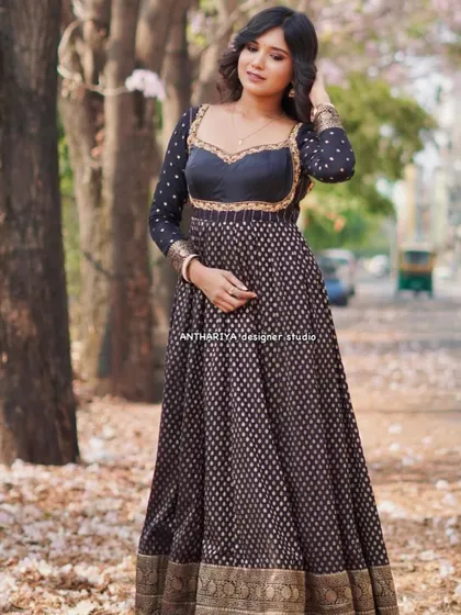 A full-length view of the black and gold Anarkali-style lehenga, showing its graceful flow and traditional border.