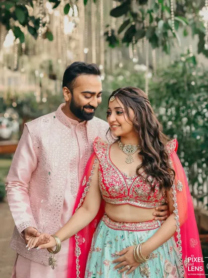 A full look of the couple at the mehendi. Their coordinated outfits and her beautiful makeup create a picture perfect moment.