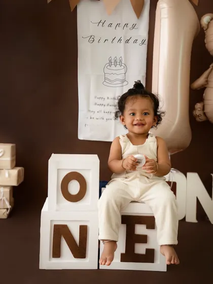 A classic teddy bear theme for this little one's first birthday portraits. The warm brown tones and adorable props create a timeless and cozy atmosphere.