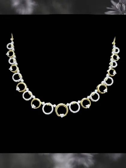 This modern necklace features circles of gold and diamonds, creating a chic and contemporary look. It is another example of our elegant, budget-friendly options.