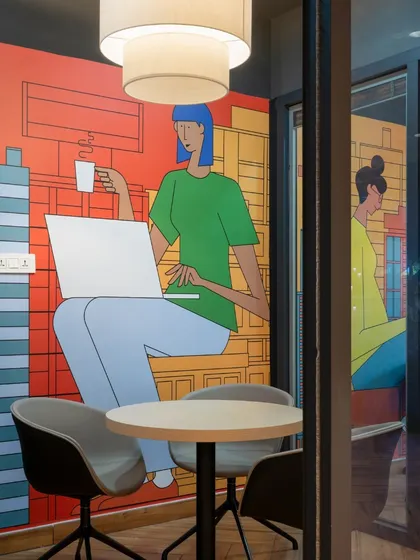 This interview room is designed to make a great first impression. The wall graphic depicts a relaxed, urban coffee shop scene, creating a comfortable and informal atmosphere for conversations.