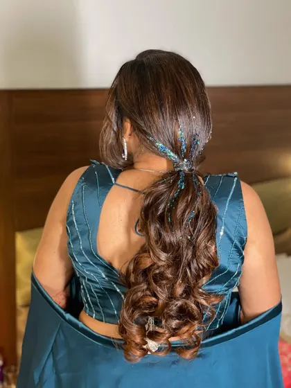 For this sangeet, I created a fun and glamorous ponytail with a side braid. The addition of glitter strands in the hair adds that extra sparkle for a night of dancing.