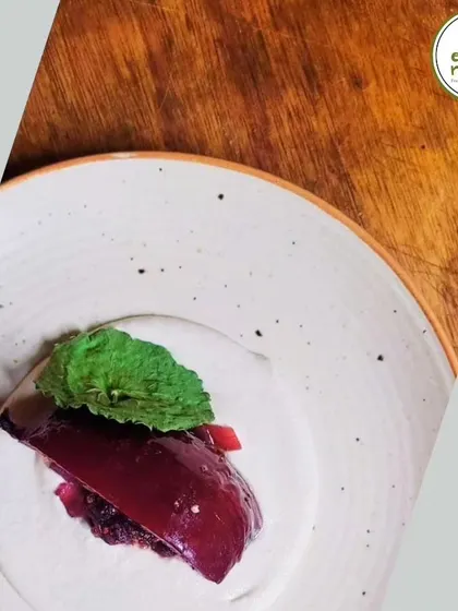 A close-up of a gourmet dish from our 'Celebrating Mulberries' dinner. This dessert features a delicate mulberry compote, showcasing the versatility of farm-fresh ingredients.