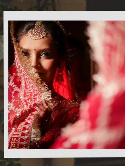 An artistic shot of a bride looking into a mirror, with her reflection creating a sense of depth and introspection.