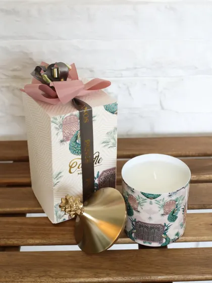 The Cactus Garden scented candle, with its unique print and gold pineapple lid. This piece brings a touch of desert charm and delightful fragrance to your home.