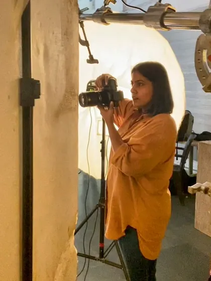 In my element, focused on getting the shot. This is a candid look at me working on set, carefully composing a shot and managing the light.