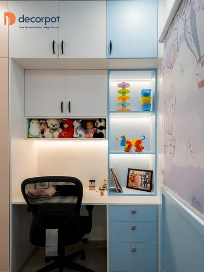 A perfect study and storage combination for a child's room in calming blue and white. The design includes open, backlit shelves for toys and a compact desk with drawers for supplies.