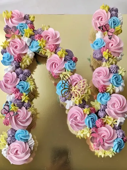 A pull-apart cupcake cake in the shape of the letter 'N'. This is a great alternative to a traditional cake, as guests can just grab a cupcake.