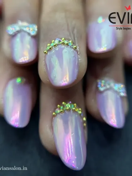 A close-up look at some of my most detailed work. These nails feature a pearlescent finish with hand-crafted rhinestone bows and tiny golden crowns at the cuticle, showing how small details can make a big impact.