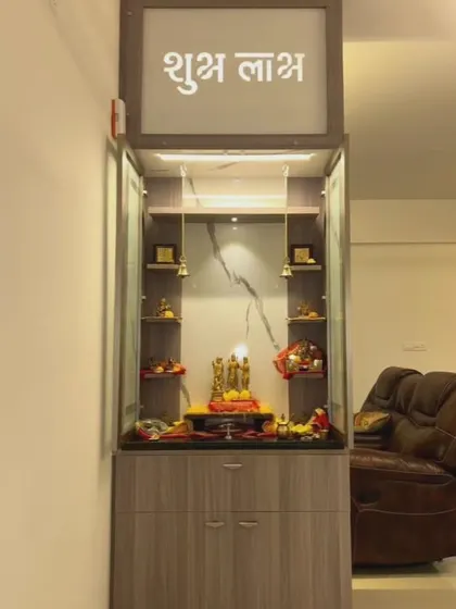 This modern pooja unit combines a marble-finish back panel with fluted glass doors and a "Shubh Labh" inscription. It's a perfect blend of elegance and functionality for a contemporary home.