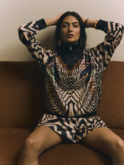 A confident and relaxed pose that showcases the full co-ord set. This image has a cool, effortless vibe that is very appealing for modern fashion brands.