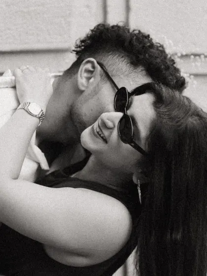 A cool and casual black and white portrait of Alicia and Jeff. The sunglasses and close embrace give this pre-wedding shot a chic, modern, and effortlessly romantic vibe.