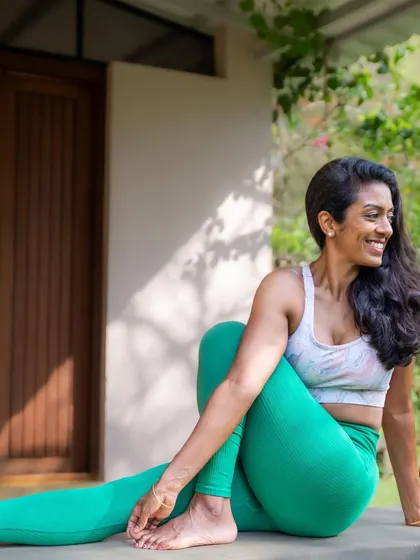 My face when lunch is ready! A playful moment captured during a yoga shoot, showing a variation of Ardha Matsyendrasana (Seated Spinal Twist).