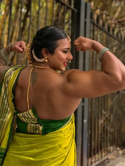 A double bicep pose in a saree, showing my back and arm definition. This is proof that strength is beautiful and can be showcased in any attire, breaking stereotypes about women's fitness.