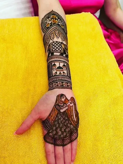 A single hand design featuring a graceful bride holding a diya. The forearm is decorated with architectural and elephant motifs, creating a rich and detailed look for any festive occasion.