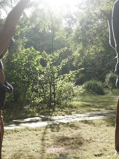 Two students practicing handstands outdoors during a Flow Fest. Nature provides a beautiful and inspiring backdrop for our training.
