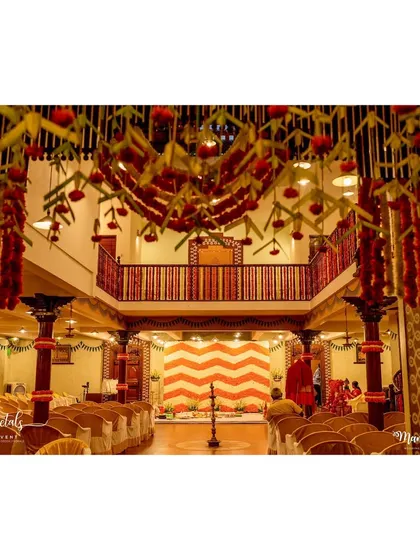 A traditional decor setup for a little one's big day at Ganjam Mantapa, featuring marigolds and other meaningful elements.