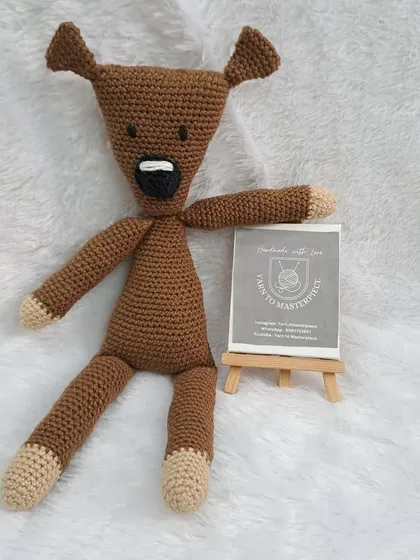 A close-up of the Mr. Bean's Teddy that was part of a larger baby gift hamper.