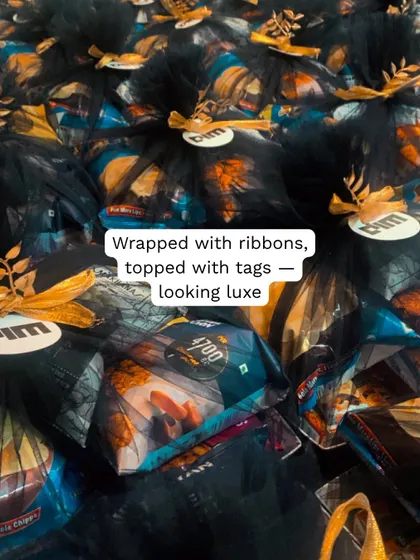 200 snack hampers delivered to Goa for a corporate event. These black net bags with golden tags were designed to look luxe and match the event's vibe.
