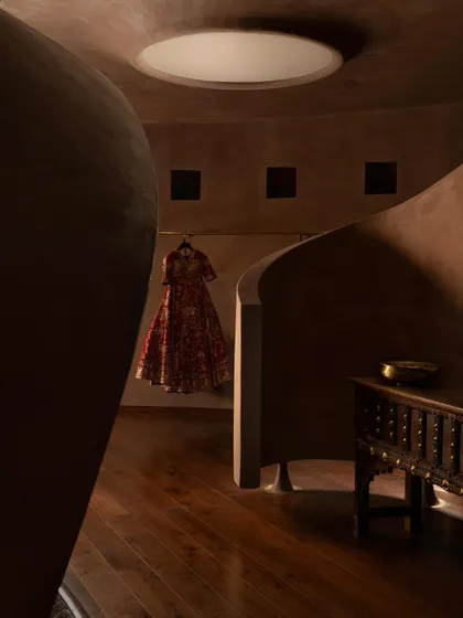 A single garment is displayed like a piece of art within a niche at the House of Masaba. The architecture frames the fashion, with soft, focused light creating moments of drama and focus.