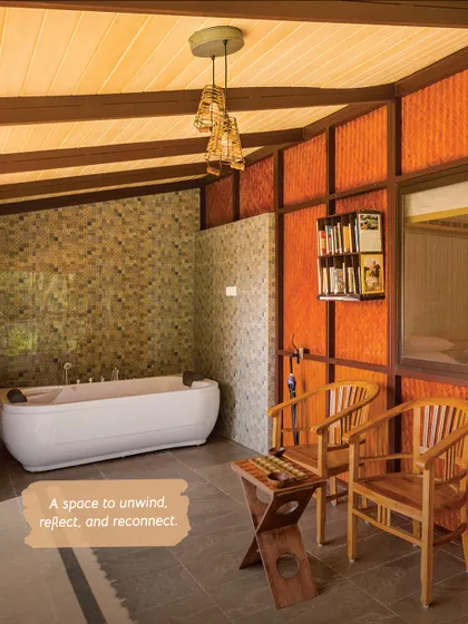 A space to unwind, reflect, and reconnect. This jacuzzi suite in Kabini features a luxurious tub and a reading nook for ultimate relaxation.