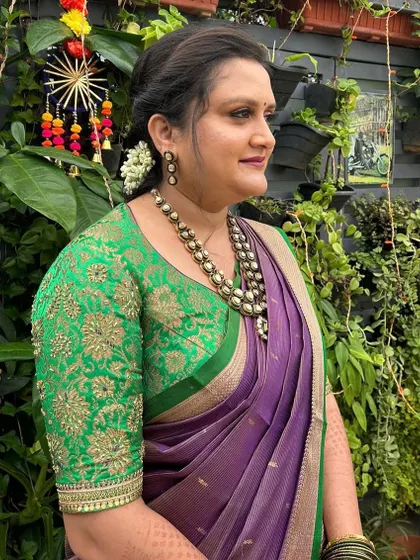 A portrait of the client in her green and purple outfit, looking elegant and ready for a celebration.
