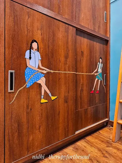 An angled view showing how the wardrobe mural fits into the overall design of the girl's bedroom, coordinating with the wooden floors and furniture.