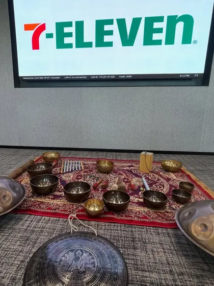 This was my setup for a sound healing session at the 7-Eleven office. I bring a variety of instruments, including handpans and Tibetan singing bowls, to create a rich, multi-layered soundscape that promotes deep relaxation.