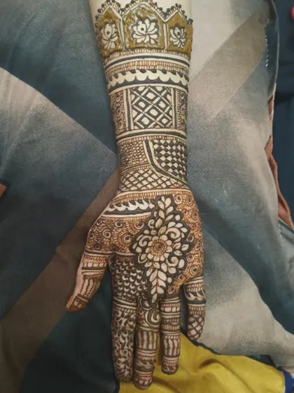 This design features a lotus motif at the cuff, a symbol of purity and beauty. The rest of the arm is decorated with geometric bands and fine-line details for a contemporary traditional feel.