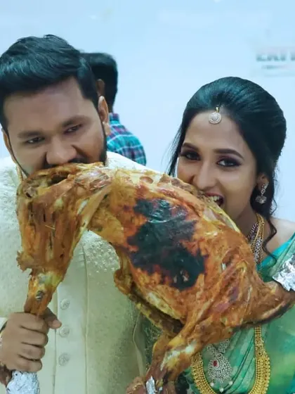 A fun, candid shot of the couple enjoying our signature whole roasted mutton.