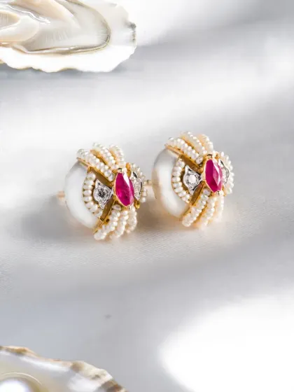 Details define a piece. These earrings from the Garden of Pearls collection feature sculpted pearls, soft curvature, and precise diamond and ruby placement, creating a design that feels both classic and contemporary.