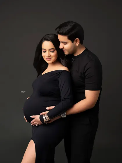 A classic maternity pose, with the partner lovingly holding the mamma and her baby bump. It’s a simple, sweet, and perfect shot.