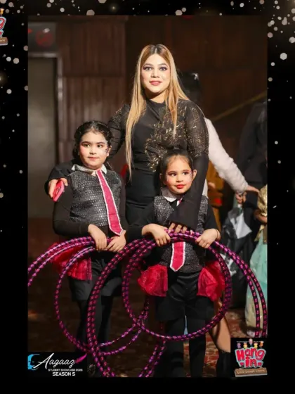 Two of our talented hula hoop performers posing with their instructor before their big moment at Aagaaz.