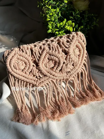This shot showcases the beautiful texture and fringing of our macramé owl bag. Each tassel is hand-finished to complete the look.