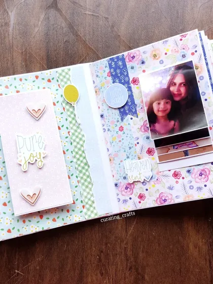 A page celebrating the "pure joy" of a new baby, with a waterfall card to show photos.