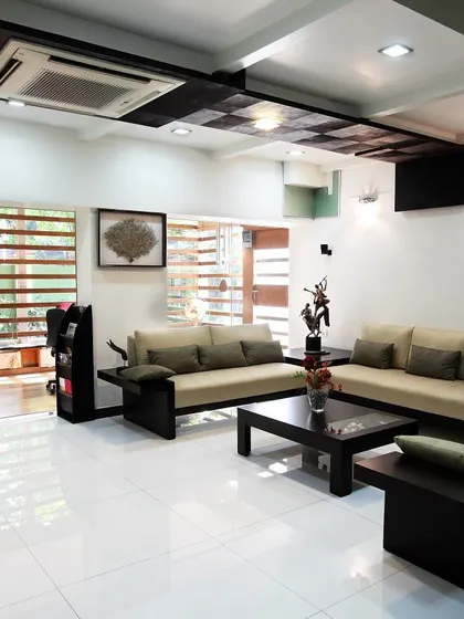The interior of the "Zingy Home," a duplex flat transformed from an old 3BHK. We removed non-structural walls and used glass to bring in daylight and create a visual connection between the living area and the new home office.