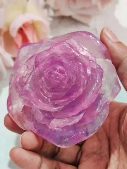A close-up of a stunning rose soap made with transparent soap base.