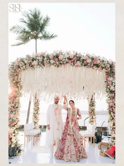 A destination wedding in Goa, with the sea as a witness. This wide shot captures the scale and beauty of a beach wedding ceremony, from the stunning floral mandap to the serene backdrop. It shows our expertise in handling large-scale destination weddings and creating breathtaking compositions.