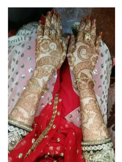 A beautiful photo of a bride's hands after the henna has fully matured. The intricate details are still sharp and clear in the dark stain.